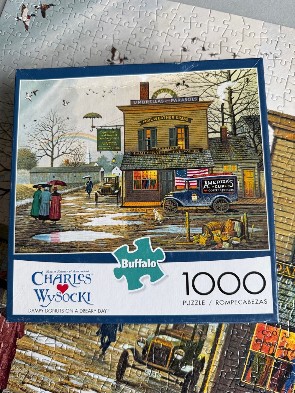 Charles Wysocki Buffalo 1000-Piece Jigsaw Puzzle - Dampy Donuts on a Dreary Day